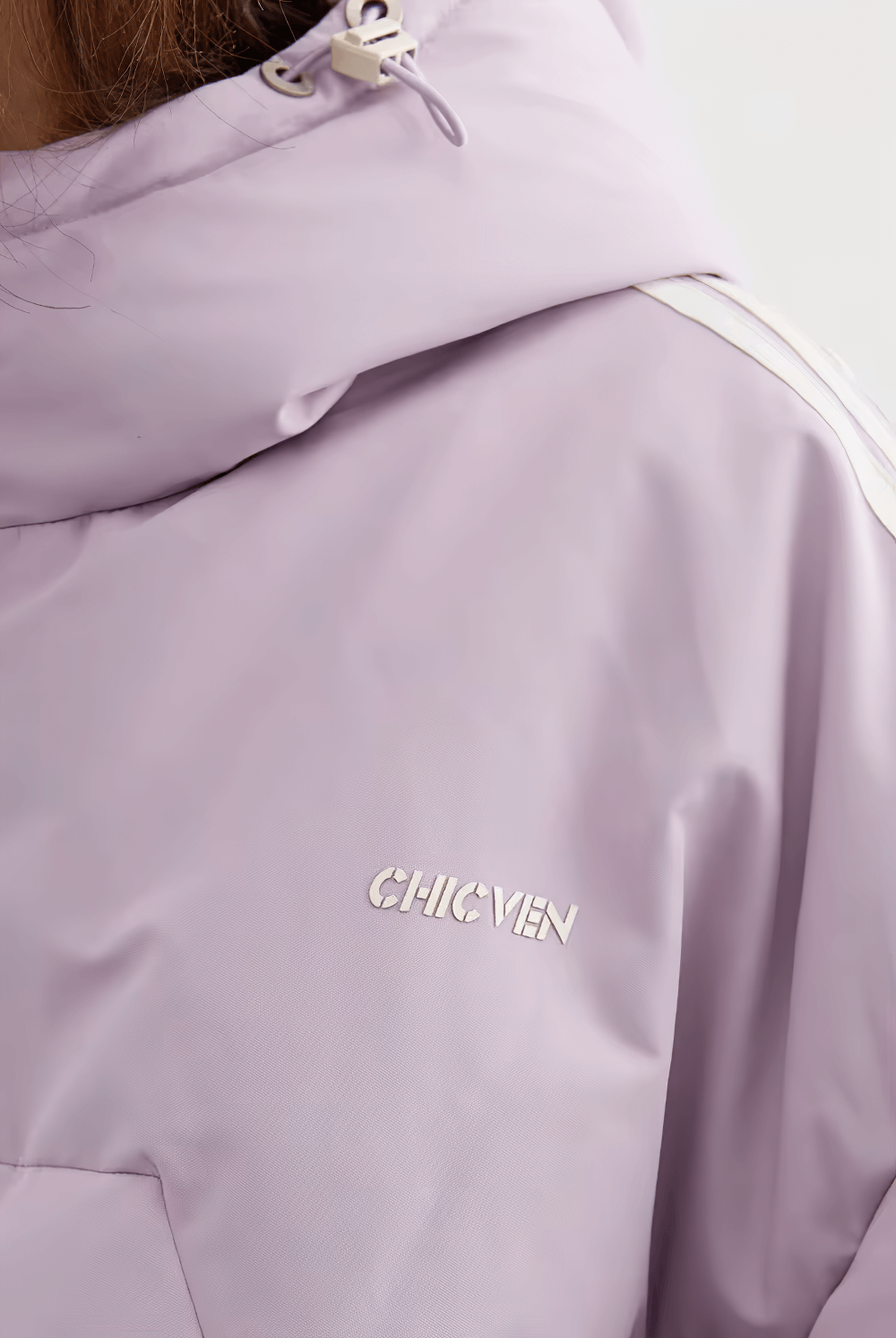 Close-up of a lavender hooded winter jacket with stylish brand logo "CHICVEN" embroidered on the chest.