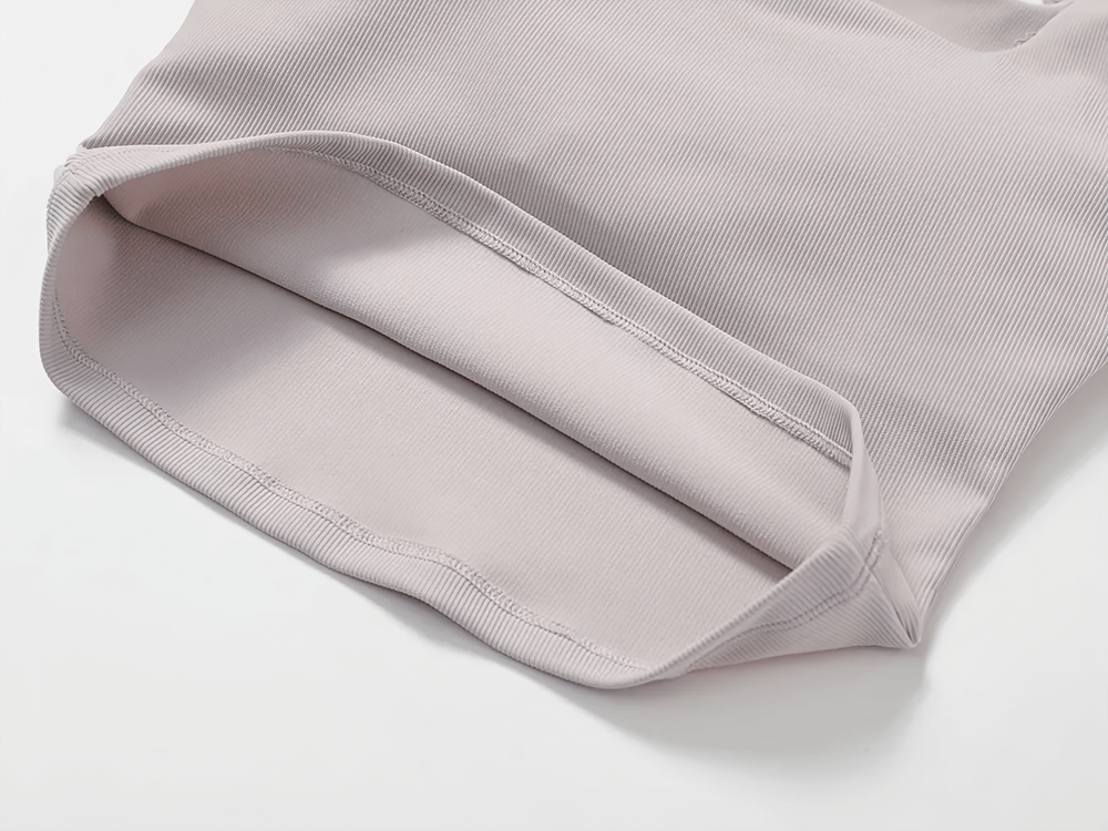 Close-up of a women's ribbed cropped tank top with lace trim, showcasing a soft, stretchy fabric perfect for gym, yoga, and casual wear.