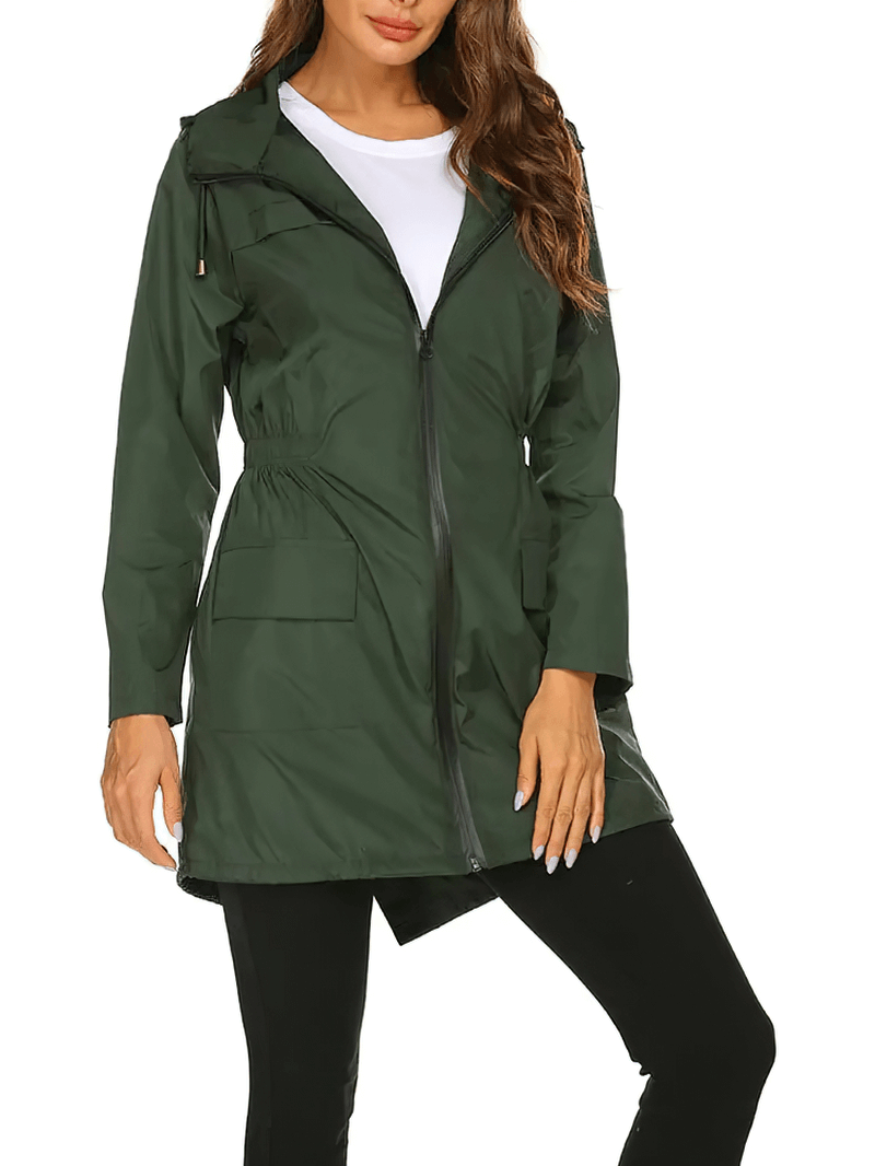 Woman wearing green hooded lightweight raincoat SF1926 with zippered closure and pockets.