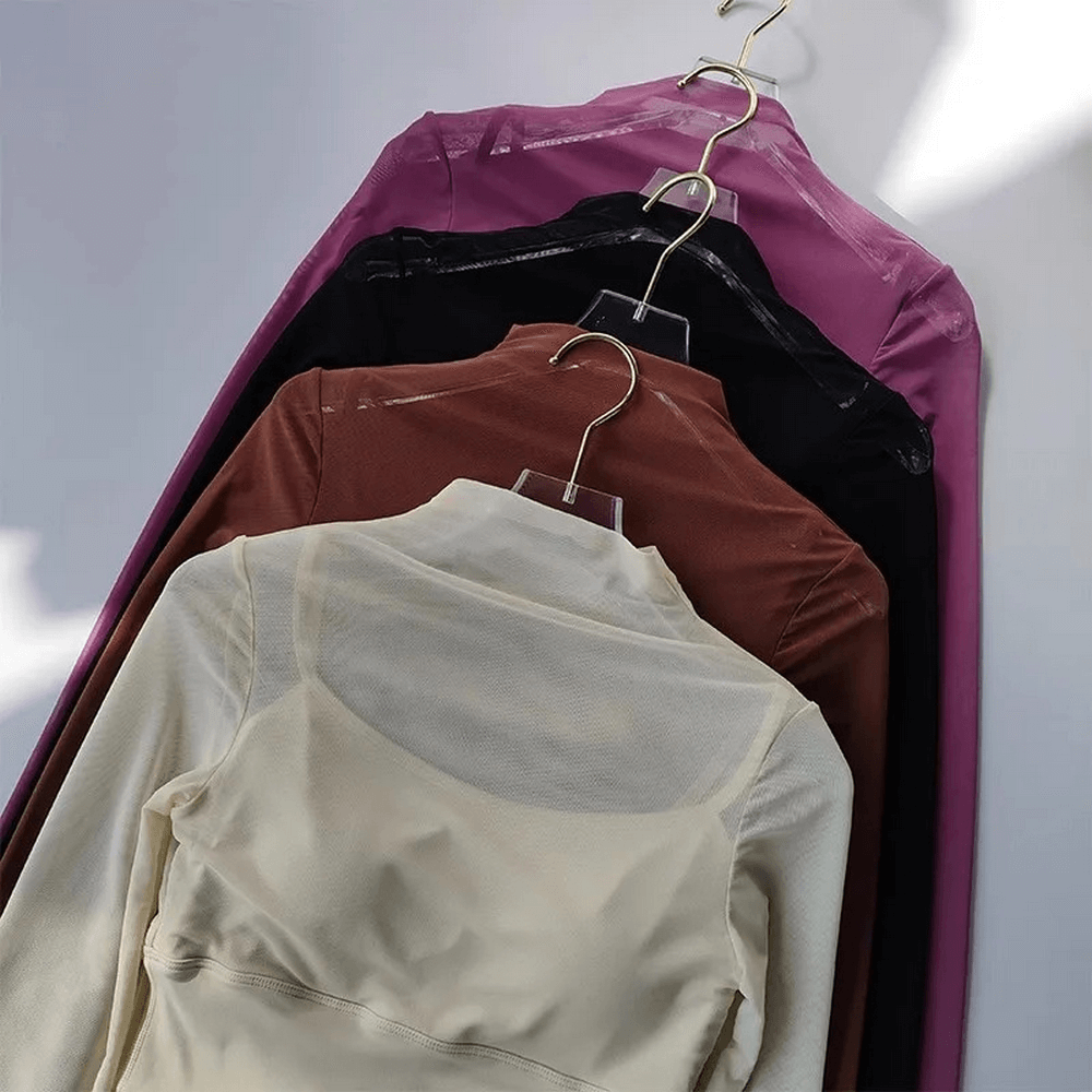Colorful Women's Long Sleeve Gym Mesh Crop Tops on hangers, showcasing stylish, breathable, and quick-dry athletic wear.