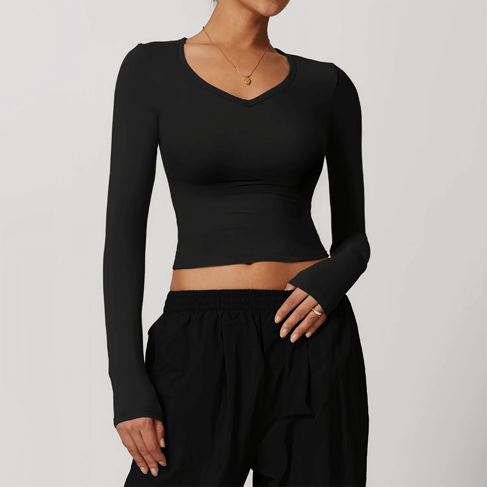 Women's black long-sleeve quick-dry yoga crop top, perfect for workouts. Stretchy, breathable nylon-spandex fabric.