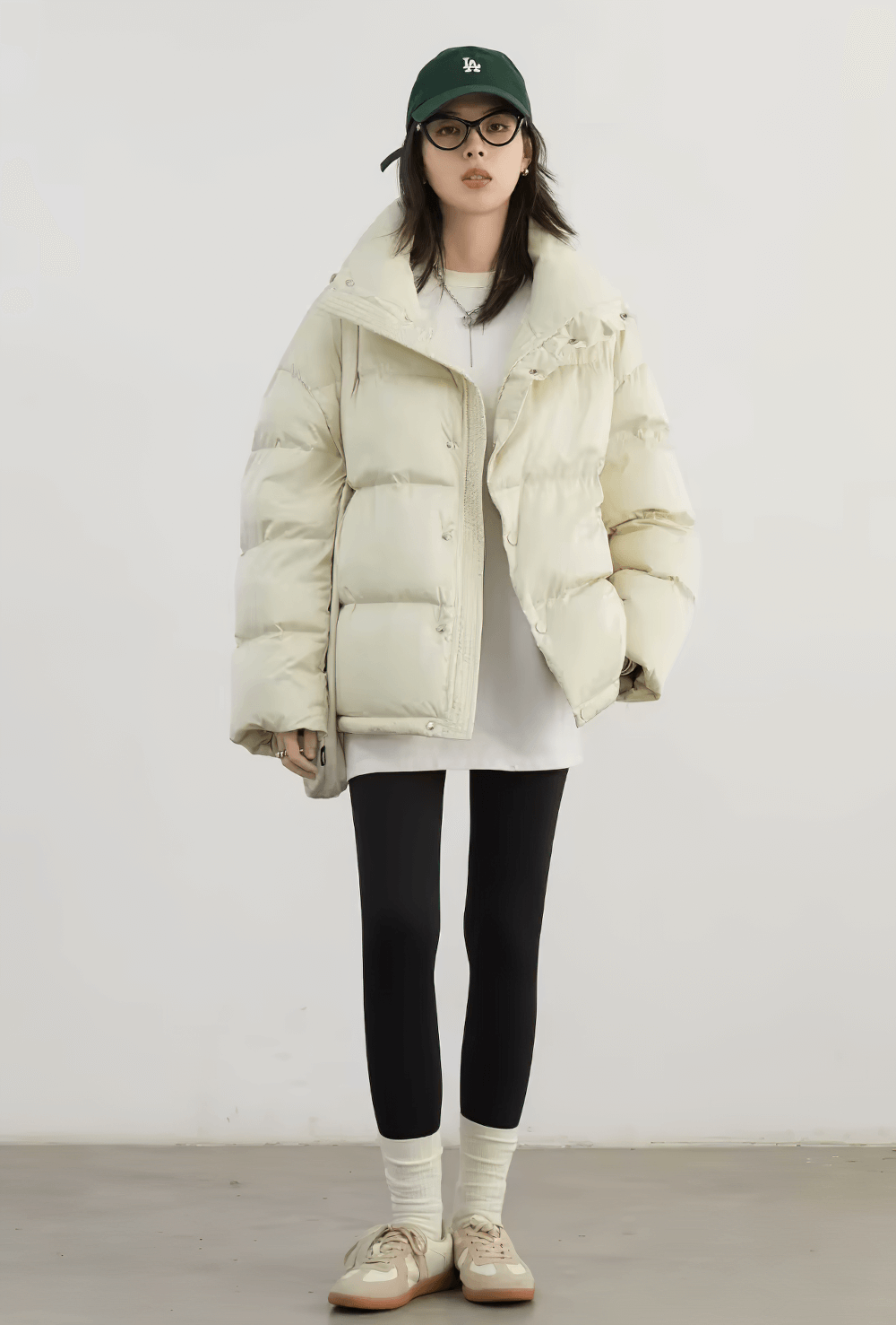 Woman wearing off-white stand collar duck down winter jacket SF2310 with black leggings and hat, showcasing casual loose style.