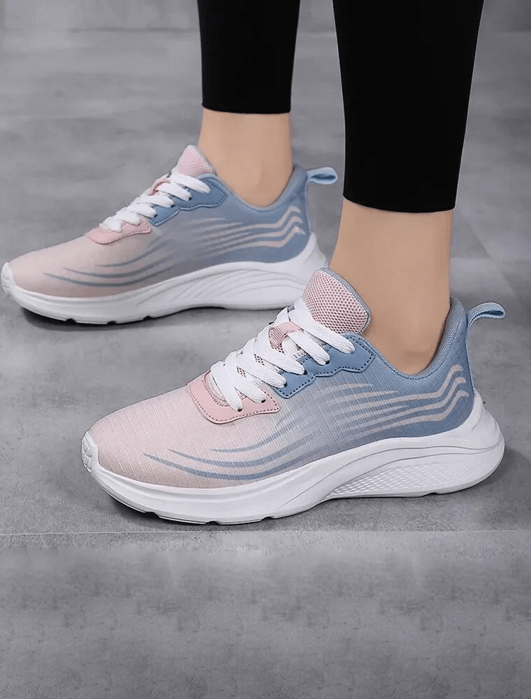 Woman wearing pink and blue mesh breathable sneakers, perfect for sports, with flexible PVC outsole and slip-on fit, model SF1708.