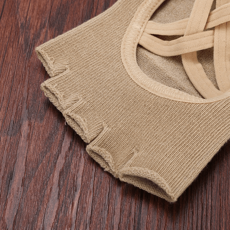 Tan five-toe yoga bandage socks, non-slip and breathable, designed for women, on a wooden surface.