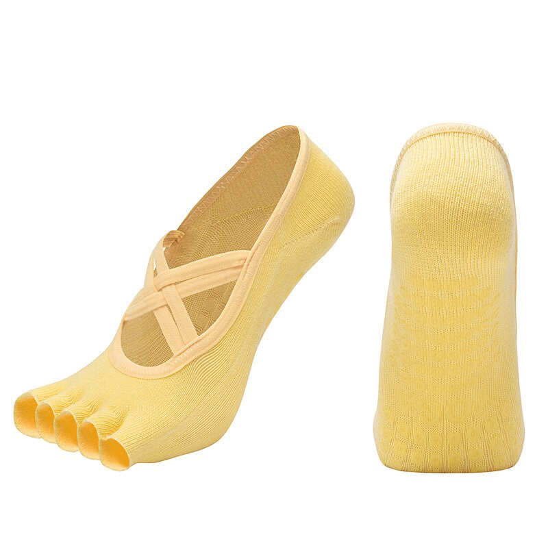 Yellow women's non-slip breathable five-toe yoga socks with bandage design, showing toe separation and grip sole.