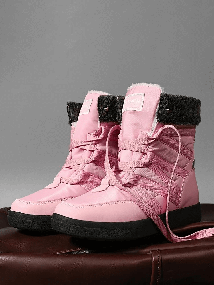 Pink women's non-slip waterproof hiking boots with plush lining and lace-up closure, perfect for outdoor adventures.