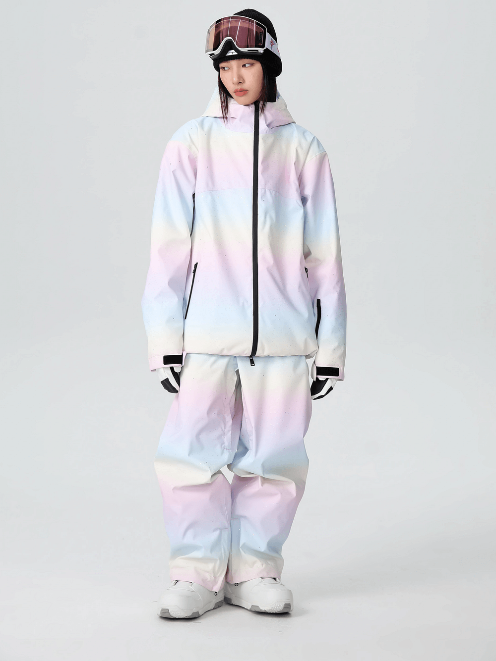 Pastel snowboarding outfit for women with waterproof jacket and pants; stylish and warm gear for trendy slopes.