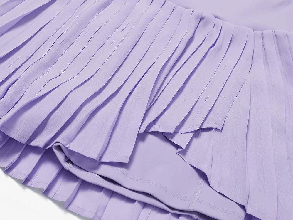 Close-up of a lilac pleated tennis skirt with built-in shorts, designed for athletic performance and stylish comfort on the court.