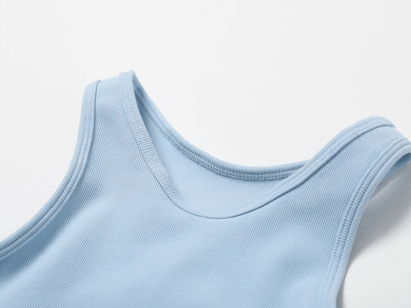 Close-up of a light blue women's push-up sports bra made of breathable, ribbed nylon and spandex material, designed for an active lifestyle.
