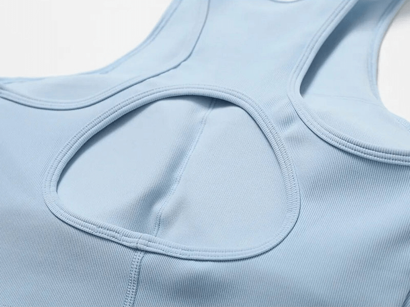 Close-up of a light blue women's sports bra with a stylish cutout back, made from breathable, quick-dry fabric for an active lifestyle.