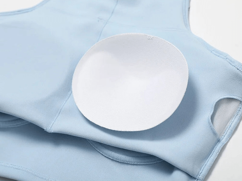 Close-up of light blue women's push-up sports bra with removable pad on display, highlighting soft, breathable fabric.
