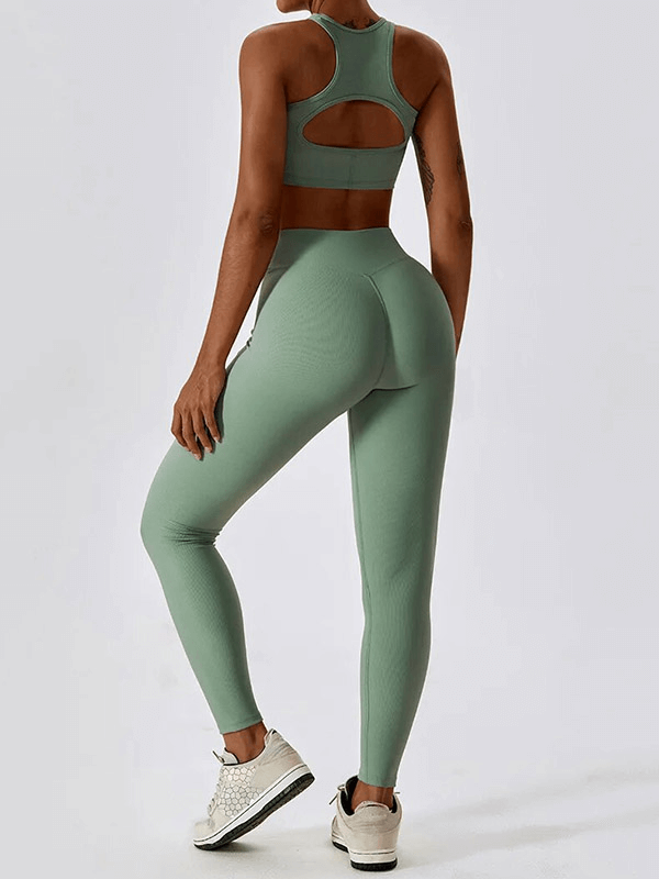 Back view of woman's push-up sports bra and ribbed leggings in green, perfect for active lifestyle. Anti-shrink, quick-dry material.