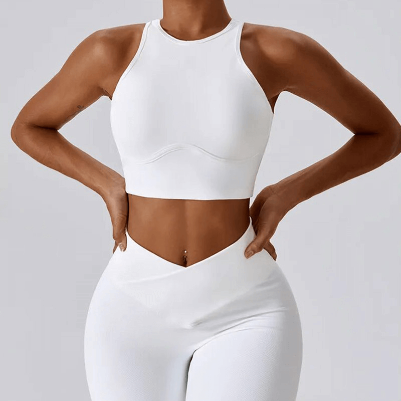 Women's white push-up sports bra and ribbed cross leggings set, designed for an active lifestyle. Comfortable, breathable, and quick-dry material.