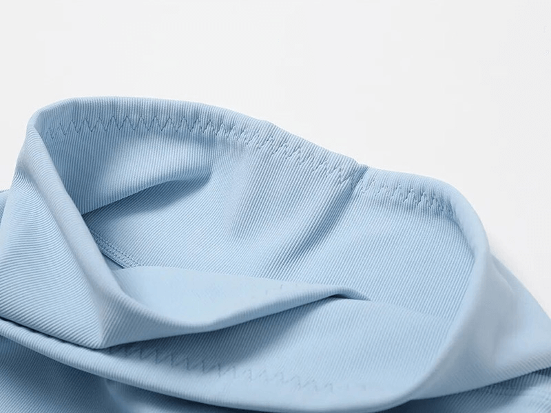 Close-up of blue ribbed cross leggings fabric, showcasing anti-pilling and quick-dry features. Ideal for active lifestyles.