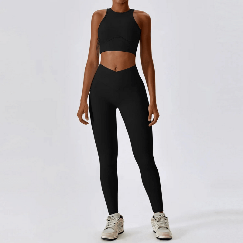Woman wearing a black push-up sports bra and ribbed cross leggings set, designed for active lifestyle, made of breathable, quick-dry fabric.