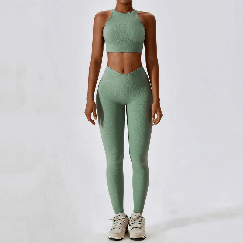 Woman in green push-up sports bra and ribbed leggings set, designed for active lifestyle. Breathable and quick-dry fabric.