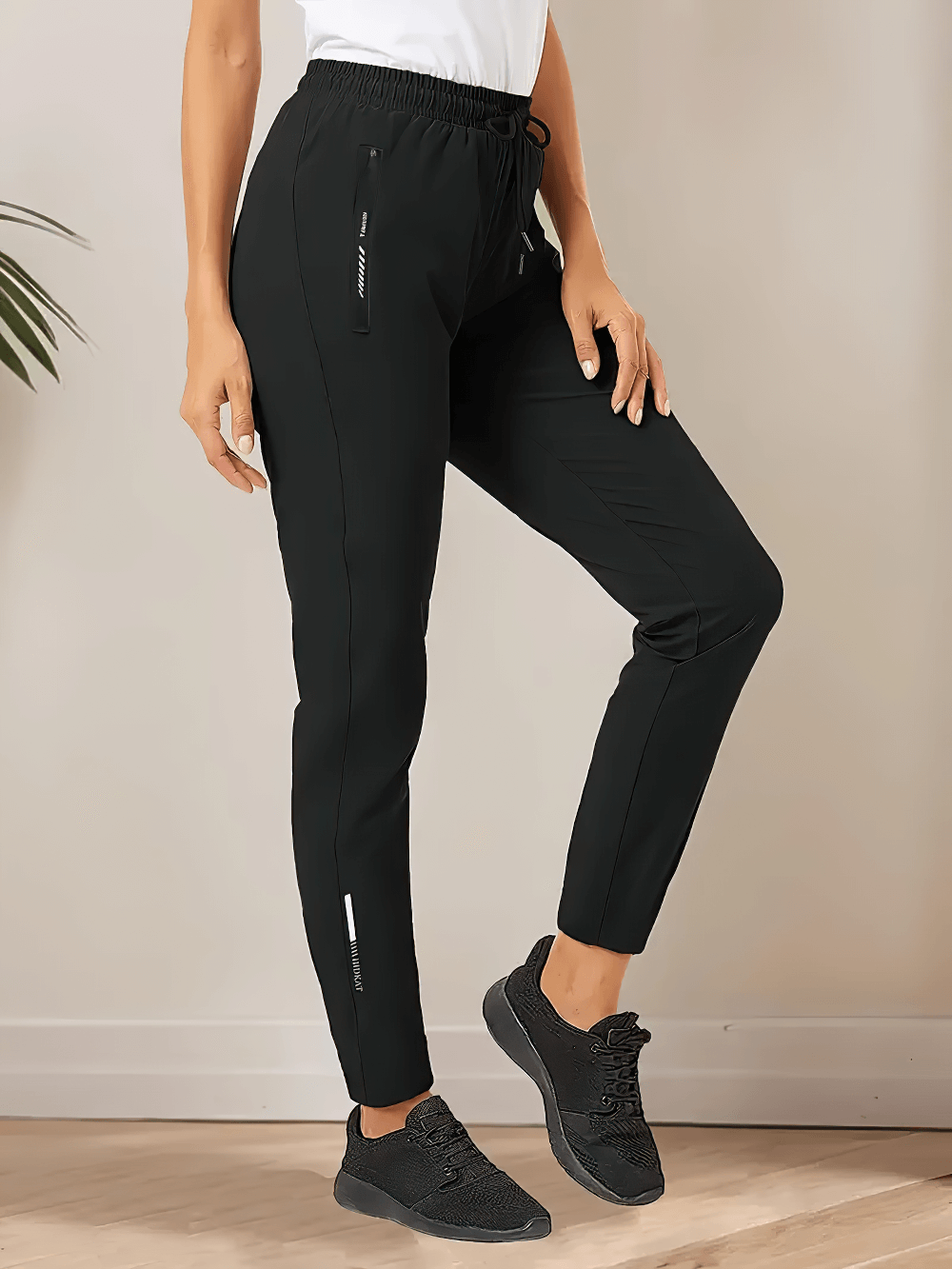 Alt Tag: Women's Quick-Dry Ankle Pants with Zip Pockets - SF4404 black tapered jogger with elastic drawstring waist and zip pockets