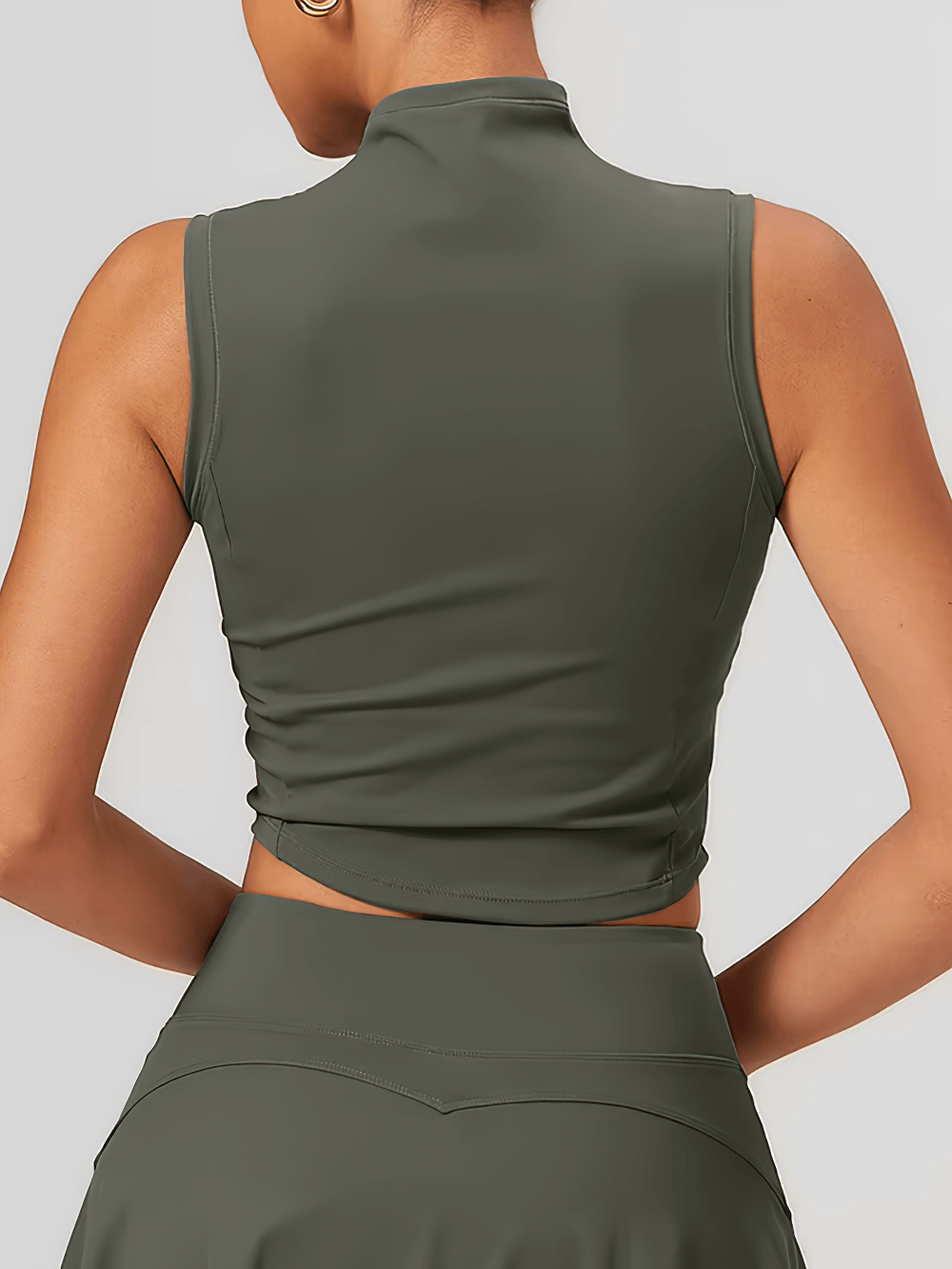 Back view of women's quick-dry sleeveless tank, ideal for running and outdoor activities, in a stylish dark green color.