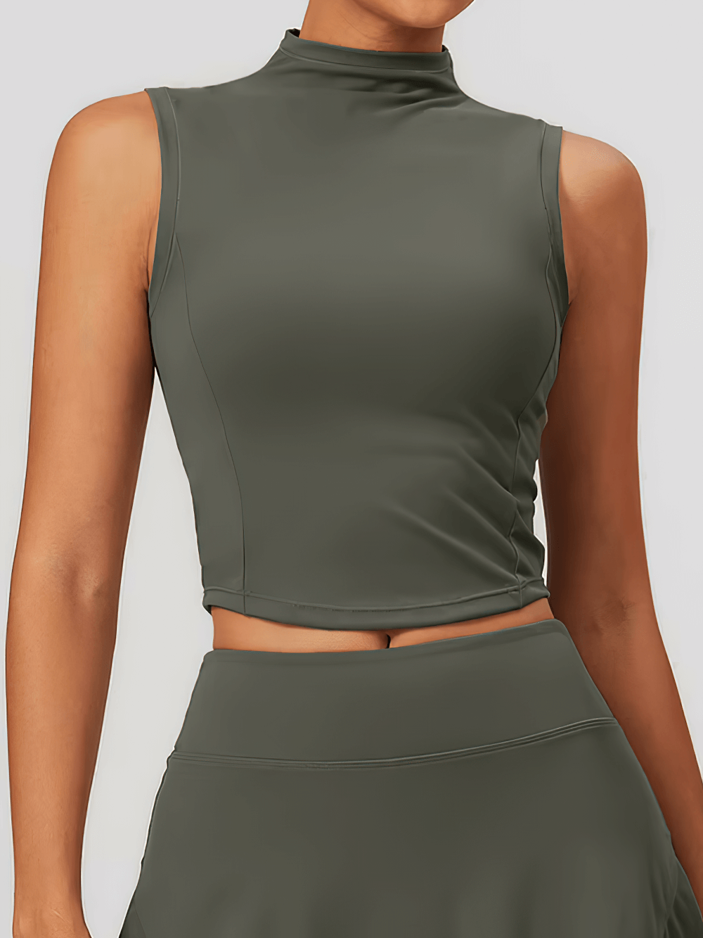 Woman wearing a quick-dry sleeveless sports tank in dark green, perfect for running and outdoor fitness activities, style SF2348.