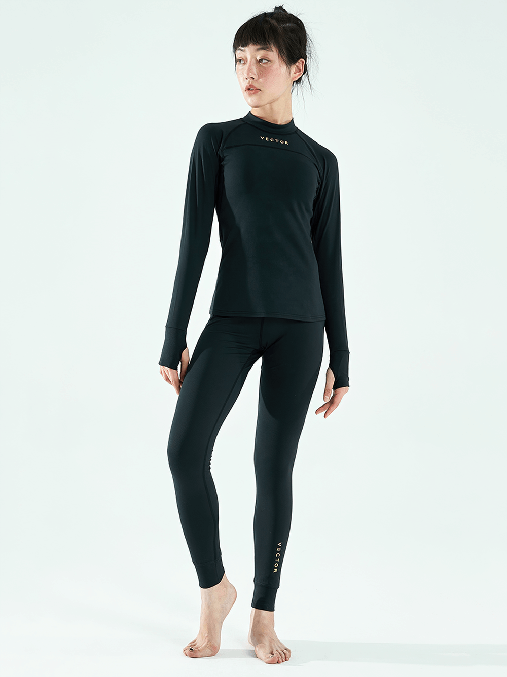Model wearing Women's Quick-Dry Thermal Base Layer Set SF2477 for skiing and yoga, showcasing stylish long-sleeve top and matching bottoms.