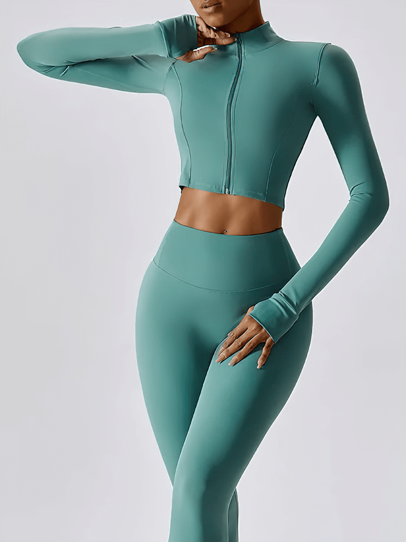 Woman modeling teal quick-drying long-sleeved yoga shirt with zipper, ideal for workouts and high-intensity activities.