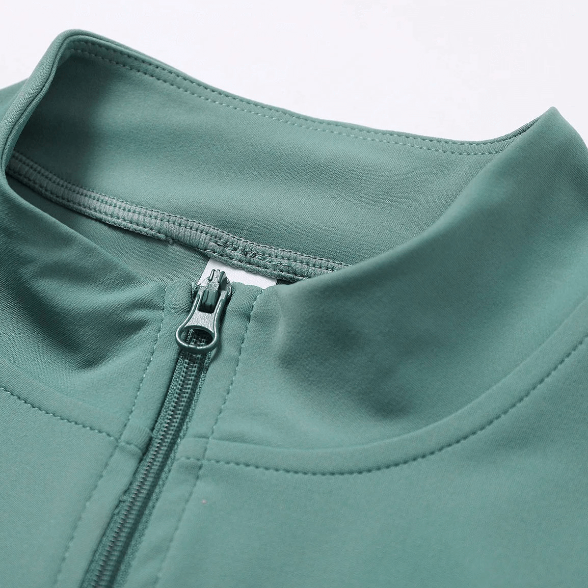 Close-up of green women's quick-drying long-sleeved yoga shirt with zipper