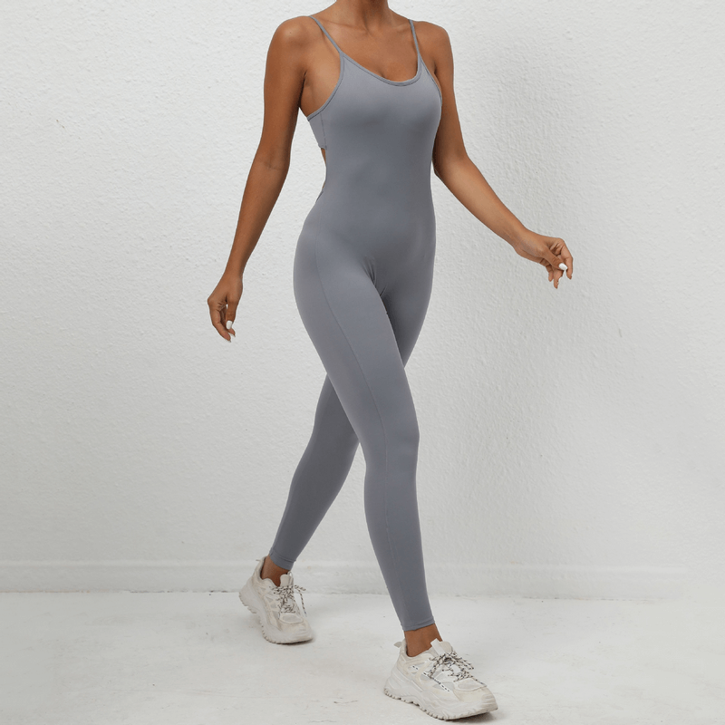 Woman in gray seamless fitness jumpsuit with sexy back and straps, perfect for workouts. Enjoy comfort and style. SF1290