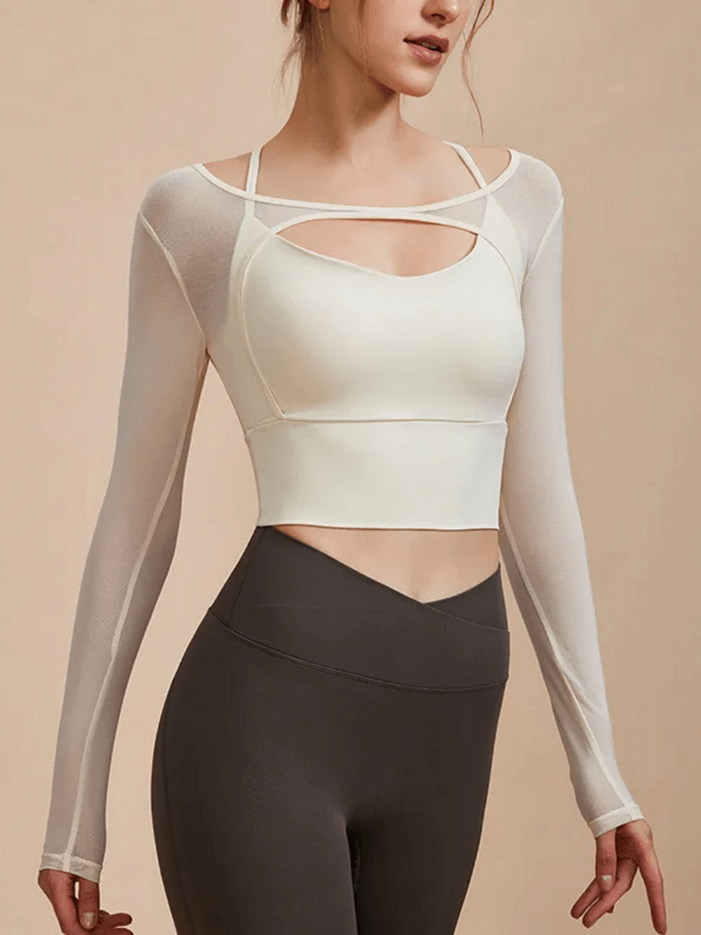 Alt Tag: Woman wearing a cream seamless long sleeve yoga crop top, SF2112, showcasing breathable, quick-dry fabric for workouts.