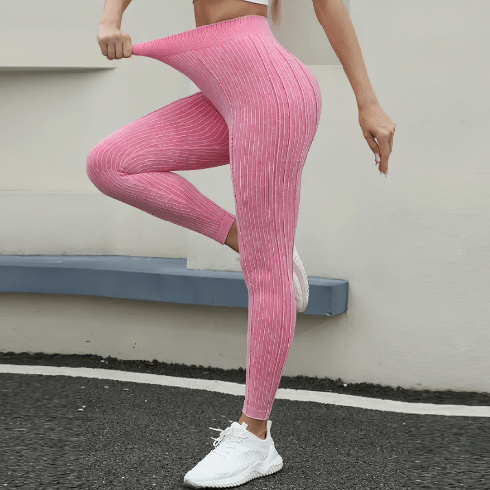 Model wearing Women's Seamless Ribbed High Waist Gym Leggings - SF4011 in pink, showing stretchy fit and hip lifting design.