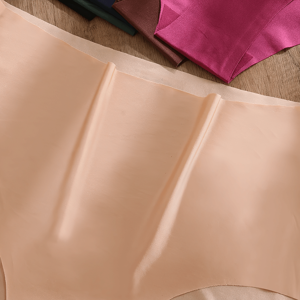 Women's seamless satin high-waist panties in beige, showcasing breathable, full-coverage design with multiple color options in background.