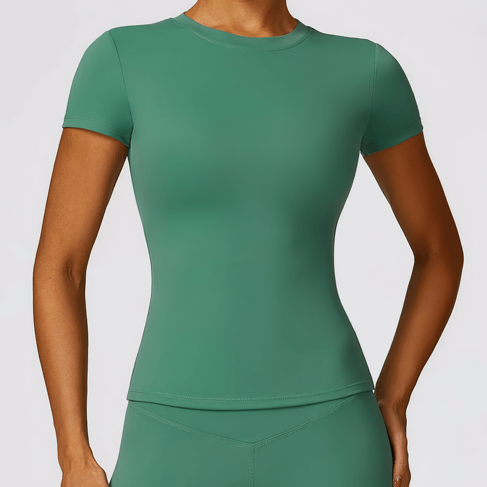 Green seamless short-sleeve yoga t-shirt for women, breathable nylon spandex blend, perfect for workouts, hiking, and running.