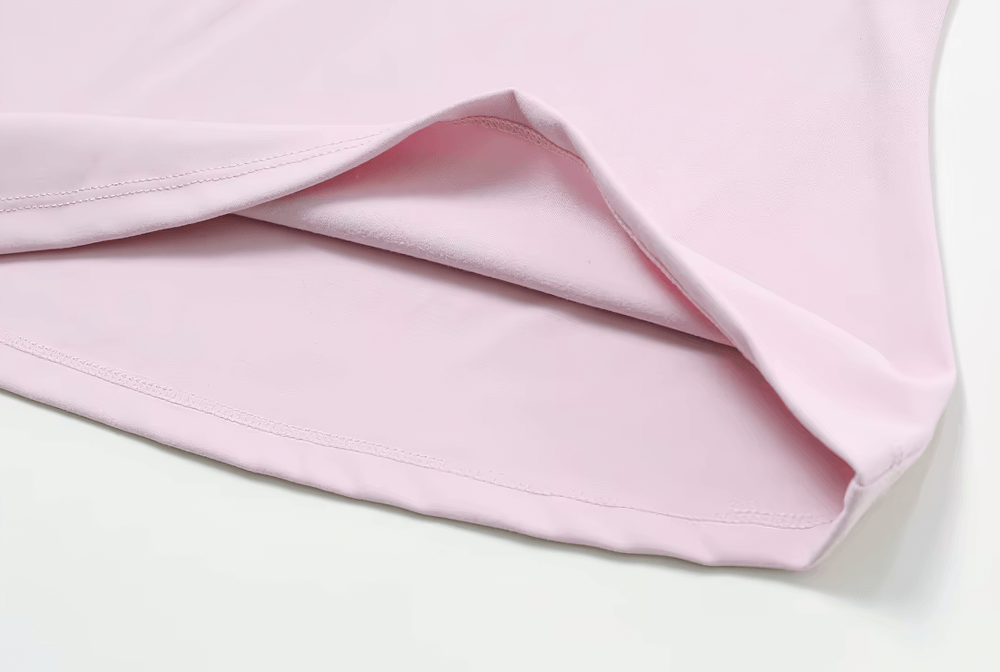 Close-up of a pink seamless short-sleeve women's yoga T-shirt showing its smooth, breathable nylon-spandex fabric.