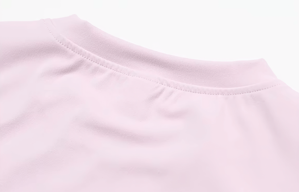 Close-up of the seamless neckline of a Women's Yoga T-Shirt, showcasing soft pink fabric ideal for fitness and comfort in workouts.