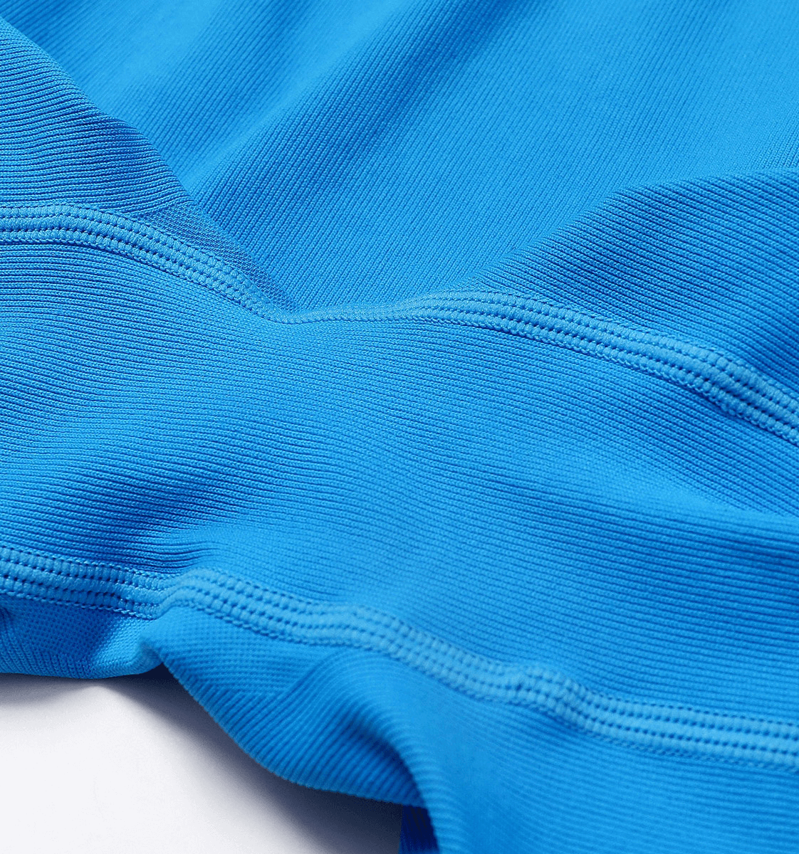 Close-up of vibrant blue fabric showing texture of Women's Sexy Back Sleeveless Jumpsuit, perfect for yoga and fitness activities.