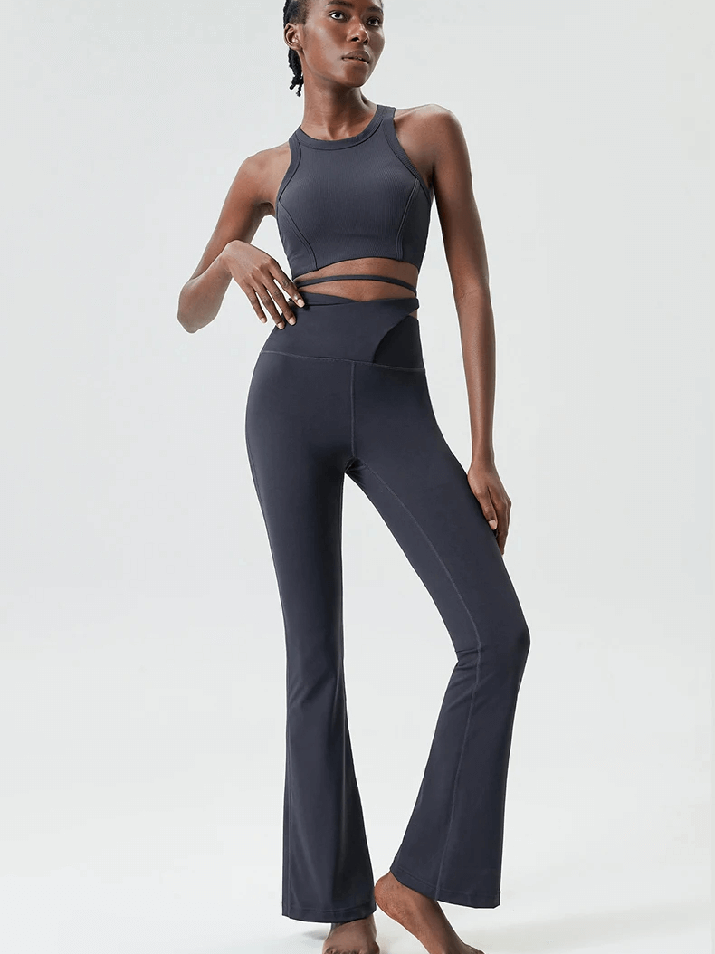 Woman wearing sleek athletic yoga pants and top set SF2085, showcasing performance fitness wear with moisture-wicking fabric.