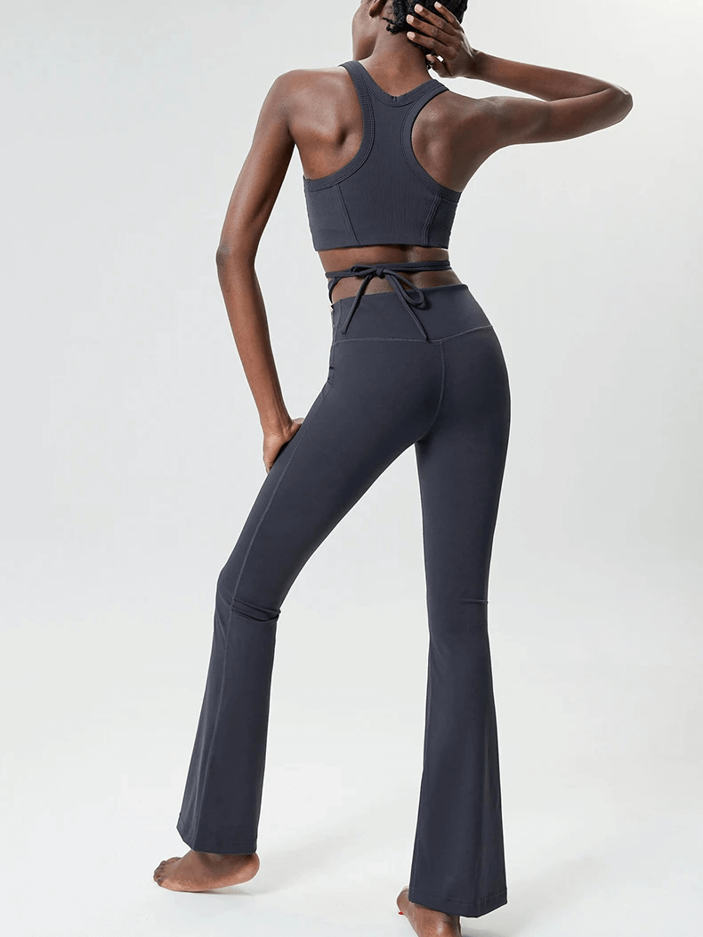 Woman wearing sleek athletic yoga pants and top set, SF2085, showcasing a stylish look with moisture-wicking fabric.