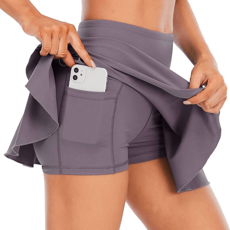 Women's high waist tennis skirt-shorts with phone pocket, showcasing durable, breathable fabric for athletic comfort and flexibility.