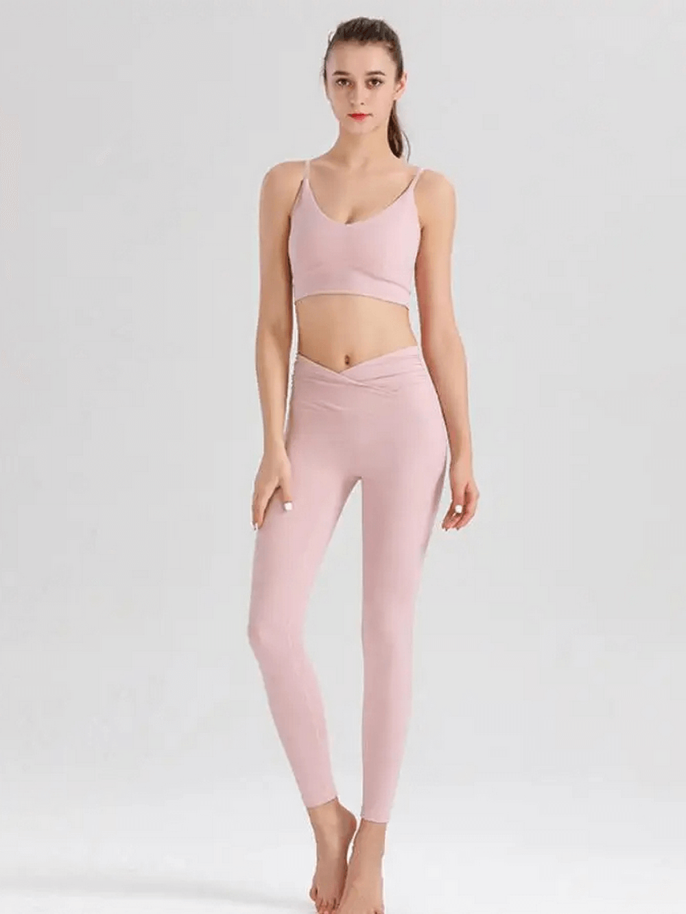 Woman modeling pink spandex workout set with sleeveless top and leggings - Women's Spandex Workout Two-Pieces Set SF2120.