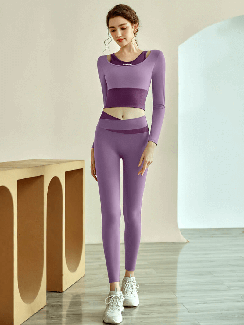 Woman wearing purple long sleeve crop top and leggings for fitness training, showcasing the stylish and breathable sportswear.
