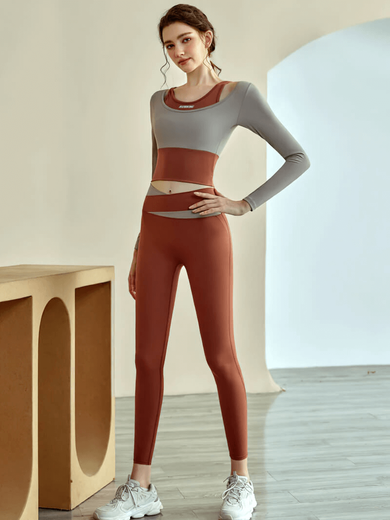 Active woman in a stylish long sleeve crop top and leggings, perfect for gym wear and fitness training. Nylon-spandex blend.
