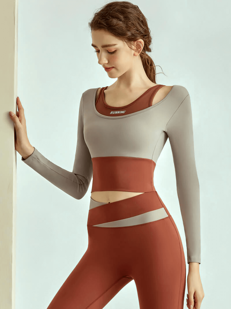 Woman wearing long sleeve crop top and leggings for fitness training, showcasing stylish activewear designed for comfort and performance.
