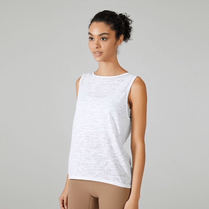 Woman wearing sporty lightweight white tank top with back cutout, perfect for Pilates and running. Comfortable cotton blend for exercise.