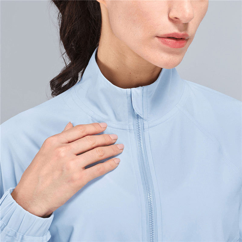 Woman wearing a light blue stand collar loose short jacket with zipper, ideal for casual sports. SF1448