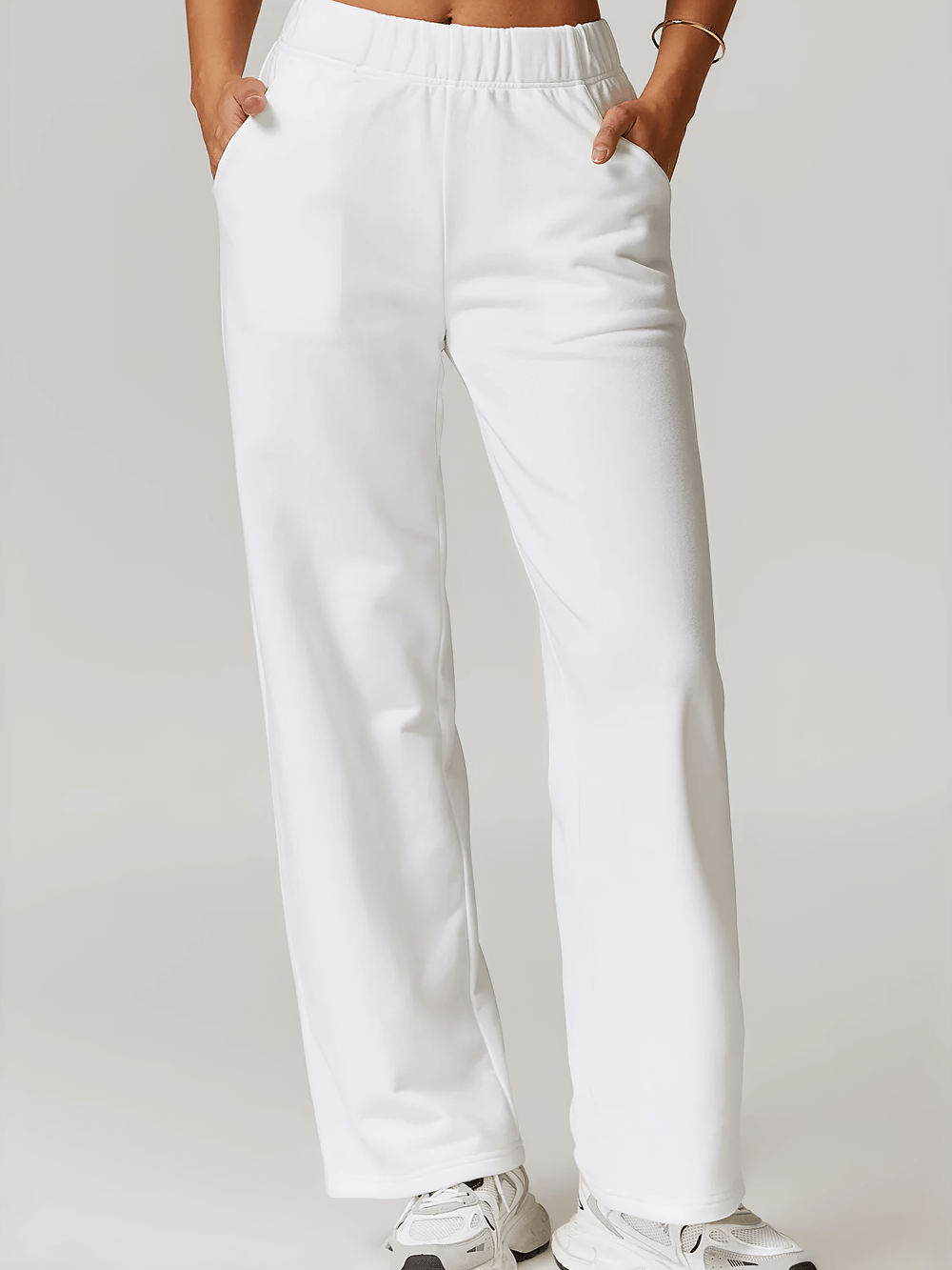 Women's white high-waist straight-leg sweatpants with practical pockets, perfect for casual outdoor sports or lounging.