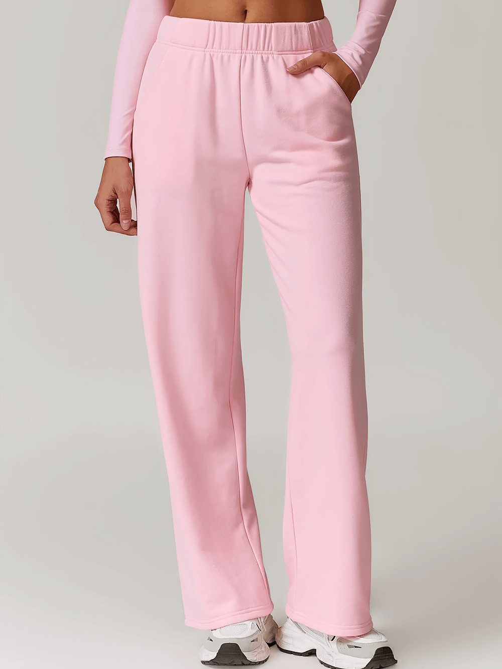 Pink women's high-waist straight-leg sweatpants SF2361, perfect for winter sports and casual wear, featuring a slimming fit and pockets.