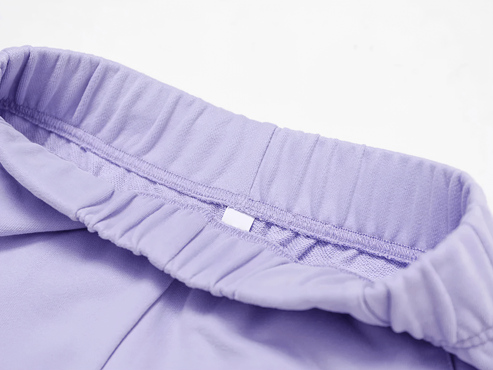 Close-up of high-waist detail on women's straight-leg sweatpants in lavender, showcasing elastic waistband for a slim-fit, casual style.