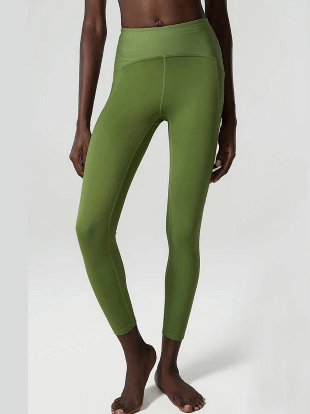 Light green women's versatile nylon-spandex leggings for yoga and gym, featuring elastic waistband and comfortable fit.