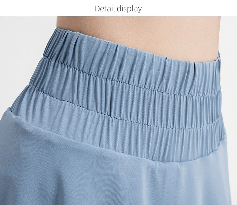 Close-up of women's tennis high waist skirt in blue, featuring a comfortable elastic waistband for enhanced mobility and breathability.