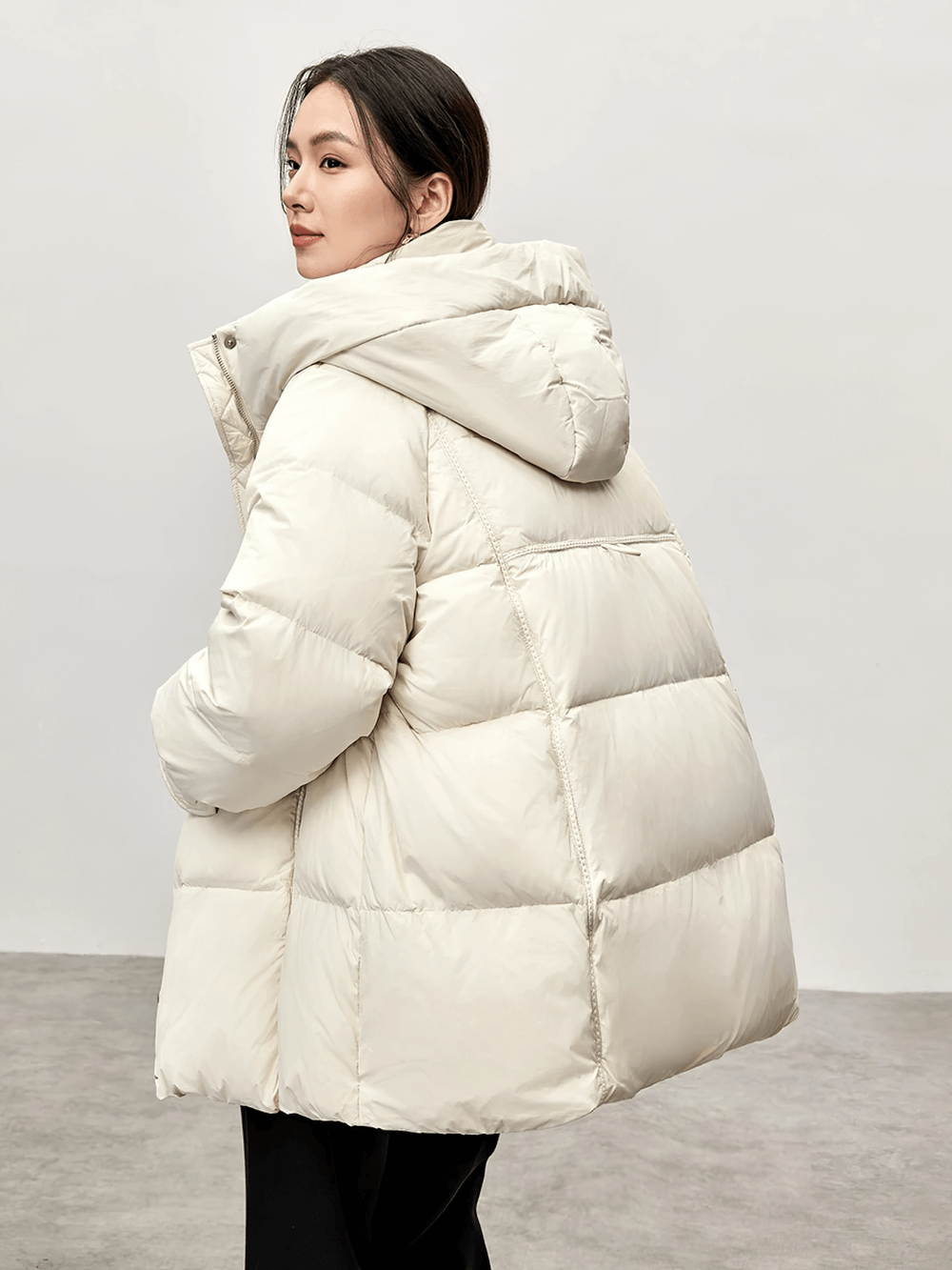 Woman in thick warm hooded white duck down puffer jacket, SF2309, wearing stylish winter coat with stand neck design