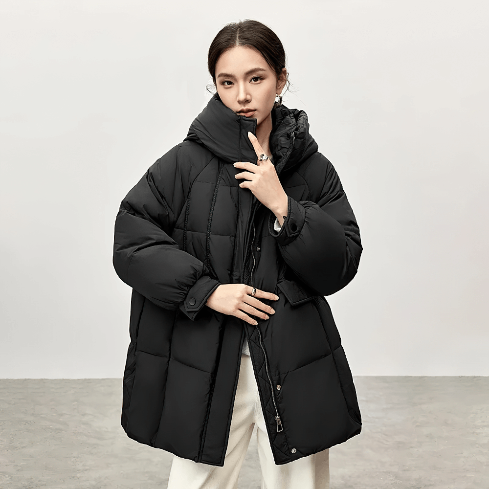 Woman wearing black women's thick warm hooded duck down puffer jacket SF2309, stylish winter coat with stand neck design.